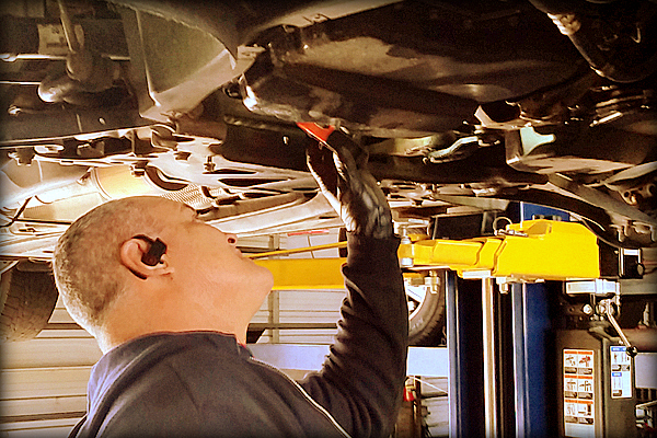 Technician Performing Maintenance on a Vehicle